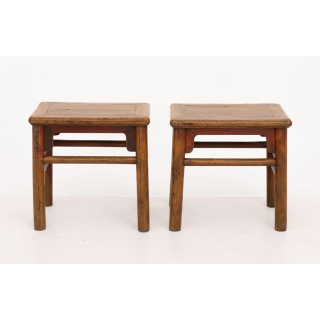 Pair of Chinese Elm Side Tables, on four cylindrical legs conjoined by box stretcher. 18.75" H x 19.5" W x 13.5" D....
