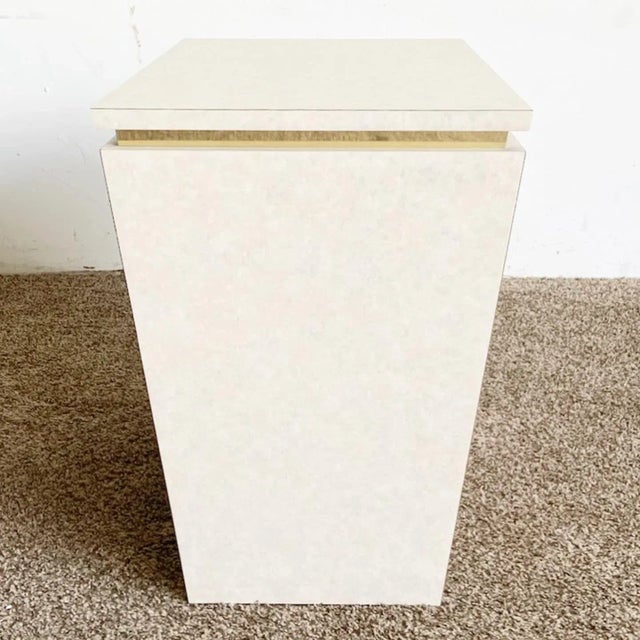 Presenting our Postmodern Beige Laminate and Gold Rectangular Side Table, an exquisite fusion of form and functionality....