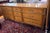 Classic vintage Kindel nine drawer dresser with a warm wood finish, framed drawer fronts, fluted details, and brass ring...