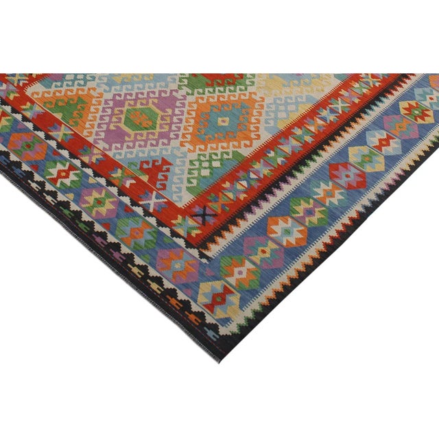 Add a touch of elegance to your home with this casual chic hand woven Tribal Kilim wool rug. Constructed on a loom by...