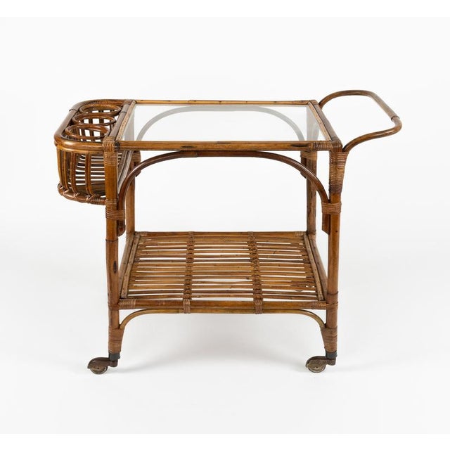Midcentury amazing serving bar cart in bamboo, rattan and glass with three bottle holder in the style of Franco Albini....