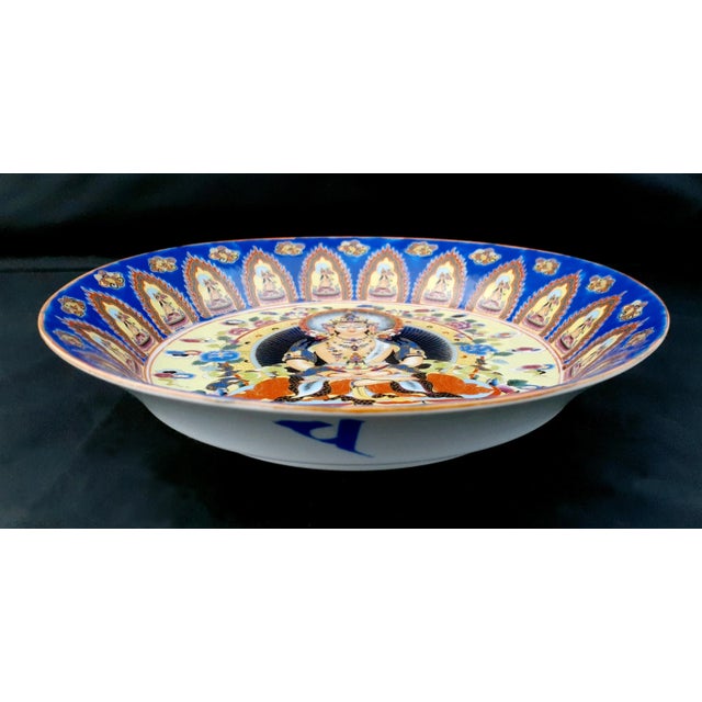 Chinese porcelain Kuan Yin bowl, with a white glazed exterior and inset base. The blue glazed, wide band below the...