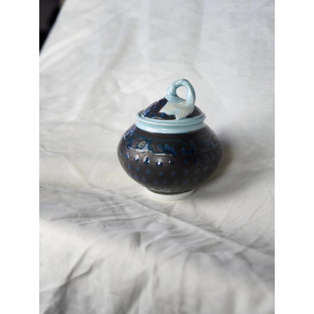 Round box in black and blue porcelain with "pumpkin" leaf lid. Carefully crafted and of noble material, this box has a...