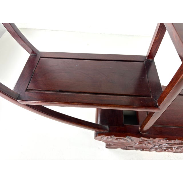 This is a late 20th century vintage handcrafted table top display shelf. This Chinese export solid mahogany display shelf...