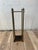 Elegant vintage brass umbrella and walking stick stand featuring a tall architectural frame with four slender columnar...