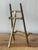 This elegant tabletop easel is a classic example of Hollywood Regency design, featuring a sophisticated reeded texture...