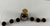 DESCRIPTION A seven-piece liquor set in deep burgundy glass: one tapered, bell-shaped decanter with a stopper and six...