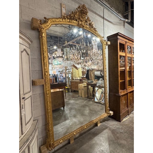 This Large Scale French Louis XVI Carved and Giltwood Mirror is a stunning piece of home decor that exudes elegance and...