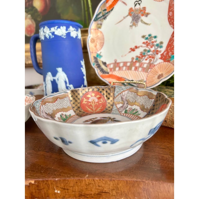 A beautifully decorated antique Japanese Imari porcelain bowl dating to the late Meiji period, featuring a graceful lobed...