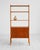 Vintage Scandinavian teak bookcase. Featuring open shelves, a storage compartment with sliding doors, and tapered legs....