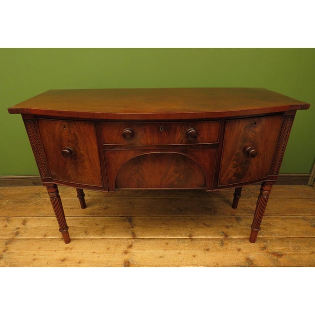 A characterful Regency style break fronted bow sideboard in mahogany. The sideboard is beautifully styled with rope...