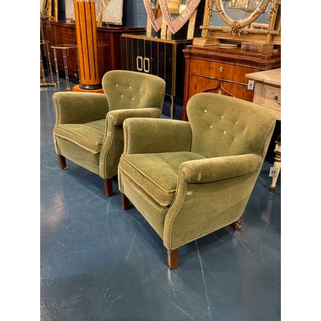 This product is a pair of Danish MCM green velour club chairs. Feature an earthy green color and a stylish Danish design....