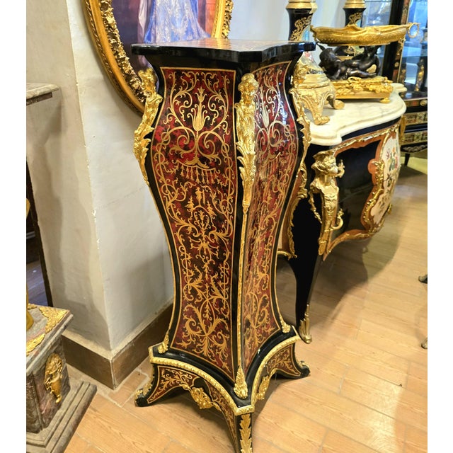 A striking example of French decorative furniture, this elegant pedestal stand combines dramatic black woodwork with...