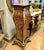 A striking example of French decorative furniture, this elegant pedestal stand combines dramatic black woodwork with...