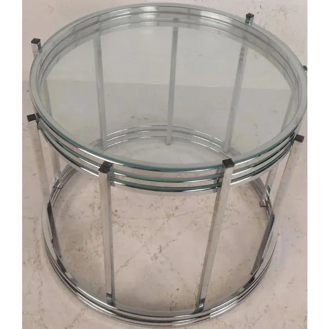 Elegant set of three vintage modern stacking tables feature a sleek circular chrome frame with vertical supports. Stylish...