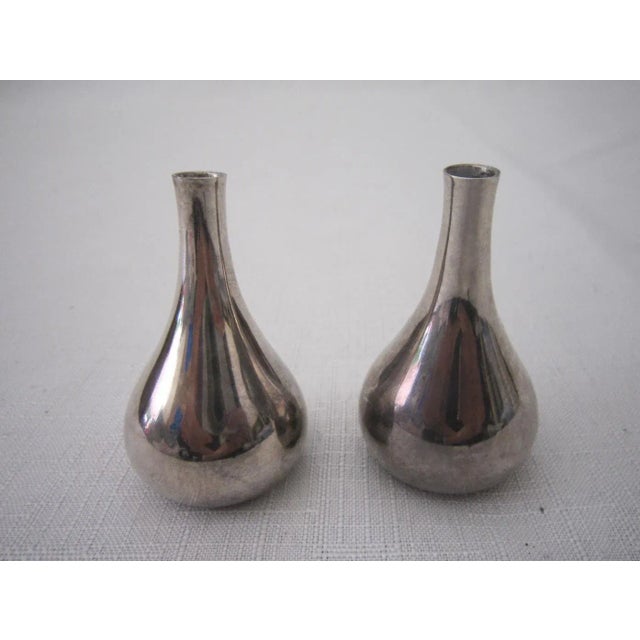 Pair of silver, mid century Dansk metal candle holders by Jens Quistgaard. Both are stamped "Dansk Made in France" on the...