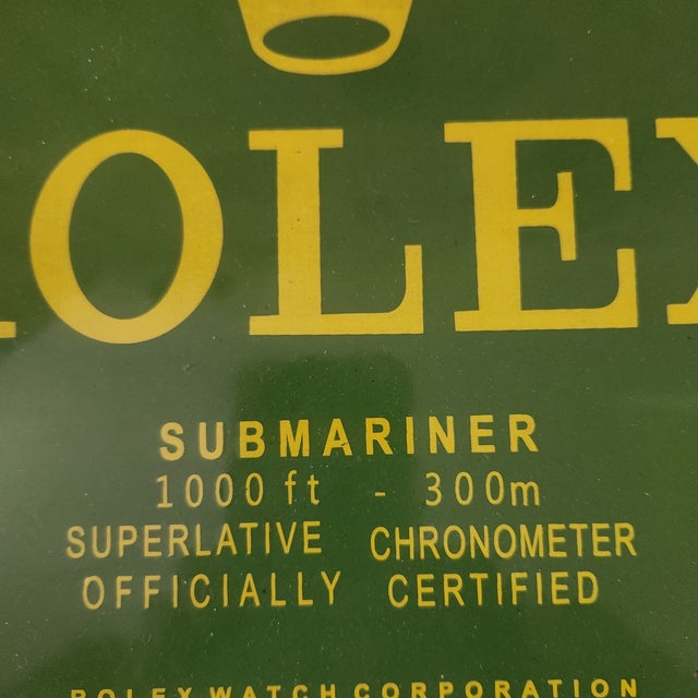 A vintage enamel on metal sign for Rolex Submariner watches. Perfect for a man cave.