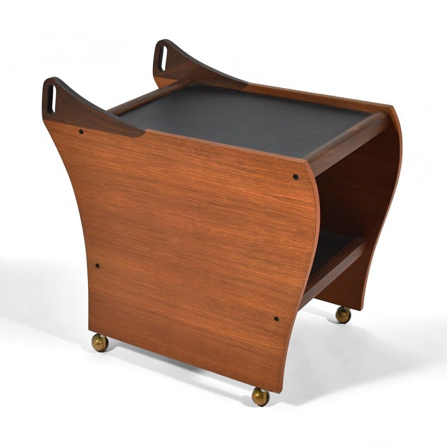 With two surfaces, casters, and handles to steer it, this beautiful teak cart is perfect as a serving or bar cart. The...
