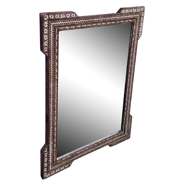 An exquisite mid 20th century Syrian mirror showcasing traditional mosaic inlay craftsmanship. The wooden frame is...