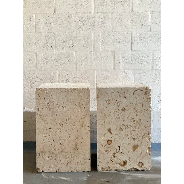 Anchor your dining space with the raw, organic luxury of this monumental pair of vintage coquina stone table bases. Carved...