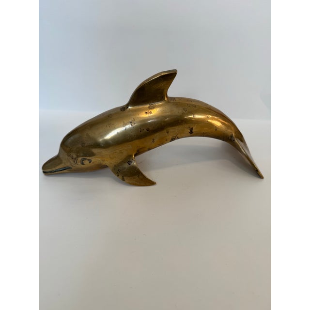 Bring a touch of coastal elegance and mid-century charm to your space with this vintage solid brass dolphin figurine. This...