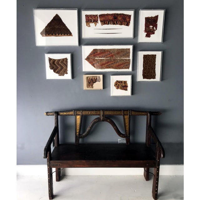 Two antique textile fragments and two painted textile tools spindle needle framed in a pair matching lucite shadow boxes....