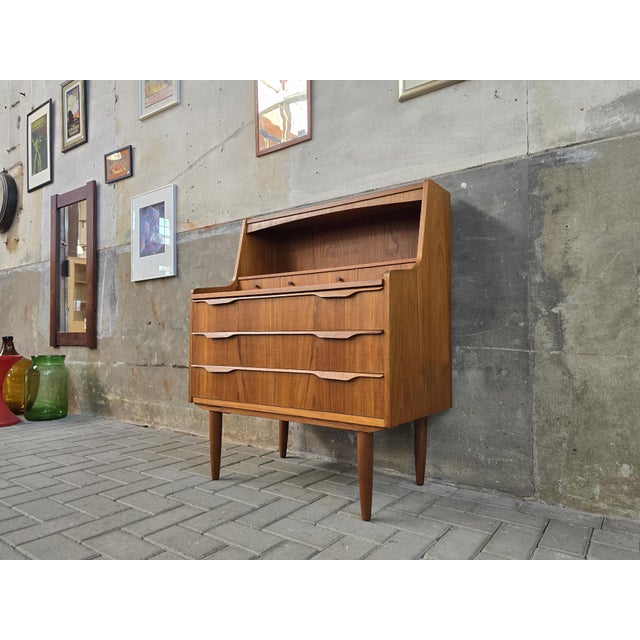 Mid Century Danish Secretary in excellent condition. The piece had three large drawers, four small ones and a large slide-...