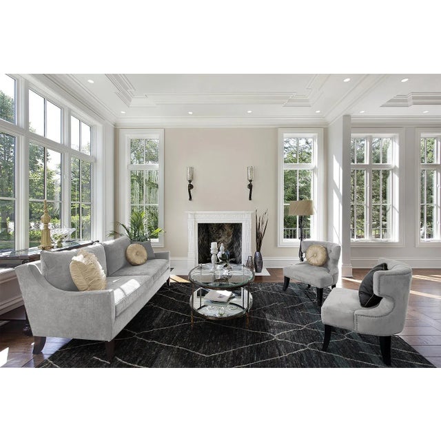 Beautiful Moroccan- Style hand-made wool rug with a black field. This Moroccan rug has accents in white, blue, and red in...