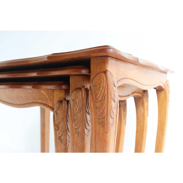 Set of three vintage oak nesting tables from the 1960s, inspired by louis xv design with elegant cabriole legs and subtle...