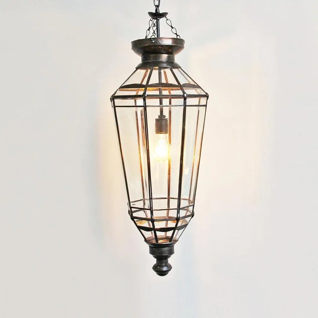 Bronzed metal work pendant lamp with beveled glass panels. Includes 3’ hanging chain and black ceiling plate. 100 watt max...