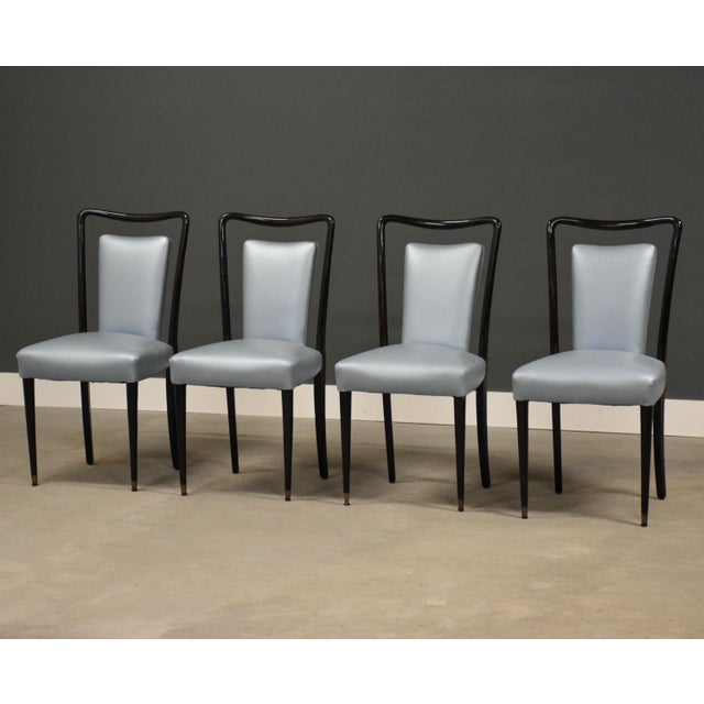 A set of four mid century modern solid beech deep mahogany color dining chairs with light blue vinyl fabric and restored...