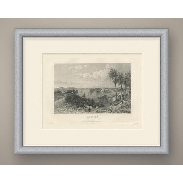 An original antique steel engraving, uncolored, titled "bombay." from a wooded hillside the view looks across a calm bay...