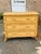 A charming vintage rattan and bamboo dresser featuring three woven-front drawers framed with natural bamboo trim and...