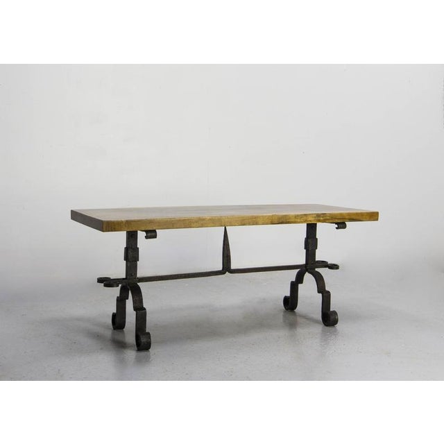 French coffee table from the 1960s made of solid wood and wrought iron French coffee table made in the 1960s, combining a...