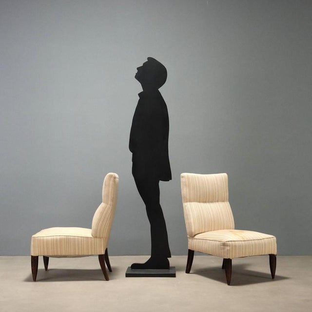 Italian-made armchairs from the 1950s-60s, characterized by a sober and elegant design typical of the period. The wooden...