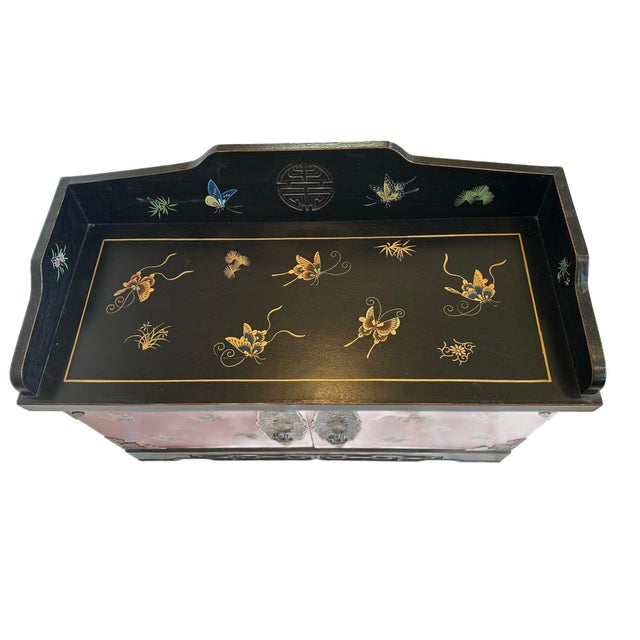 This small sized floor cabinet made in China features traditional butterfly paintings in vivid red, black and gold colors....