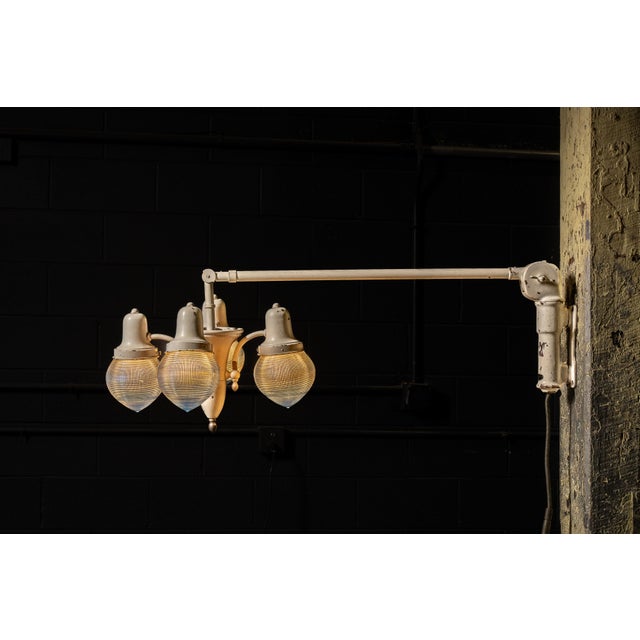c. 1930s; Harry J. Bosworth Co. - Chicago, IL Four‑light wall‑mount dental operatory lamp on a long articulating arm with...