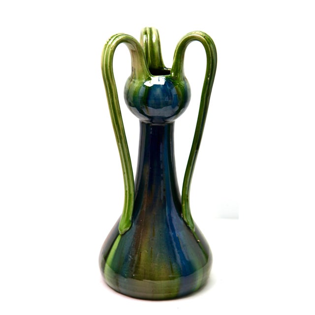 A classic example of Art Nouveau earthenware, And decorated with carefully controlled drip glazes in blue and green...