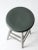 This is an antique painted swivel seat stool. The classic turned leg stools features silver metallic paint on its base...