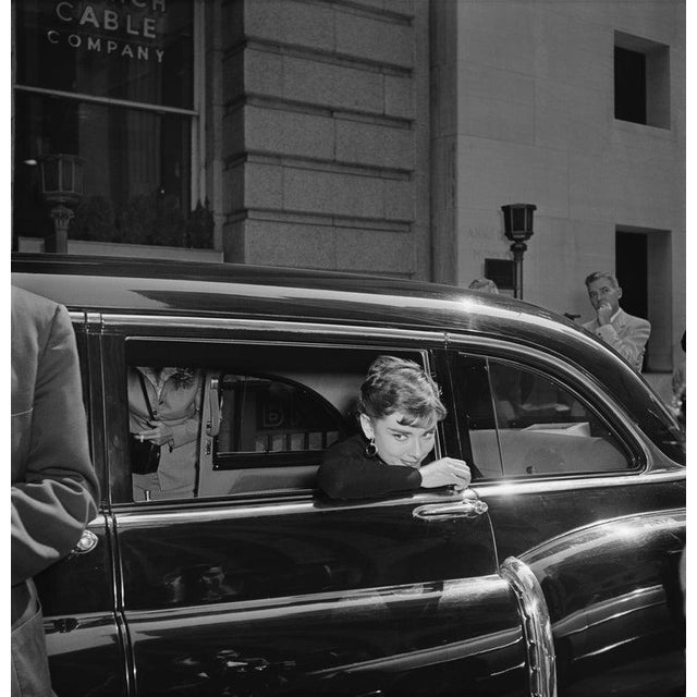 Sabrina October 1953: Belgian-born actor Audrey Hepburn (1929-1993) leans out of a car window on the set of director Billy...