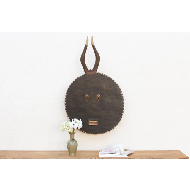 A charming African art piece, this Kple Kple mask belongs to the Goli mask group and is a symbol of fertility in...