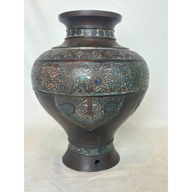 This vase depicts intricate floral designs, curves, and circles. It doesn't have a base.