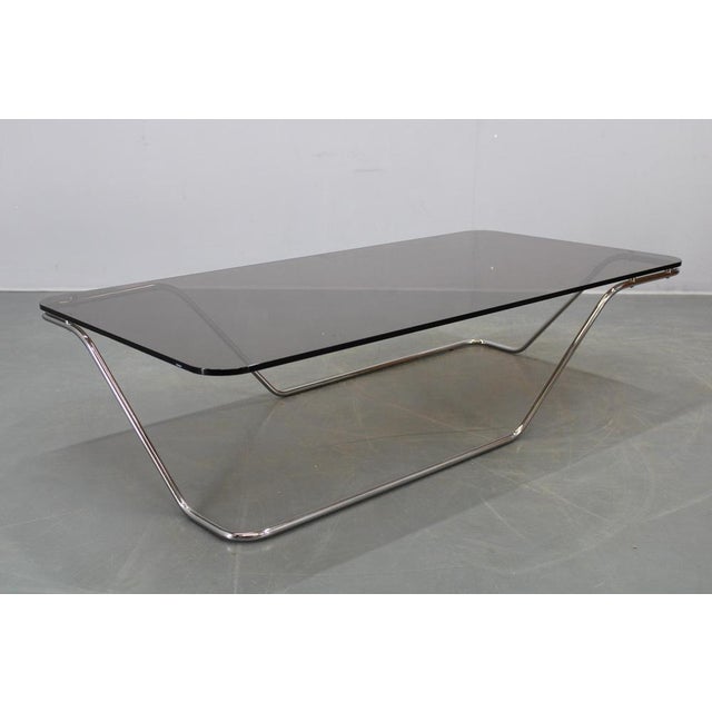 This elegant Mid-Century Modern coffee table was produced in Italy during the 1970s and exemplifies the refined balance...