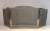 This neoclassical style fireplace screen is made of brass and grilling. This is a French work, circa 1970.