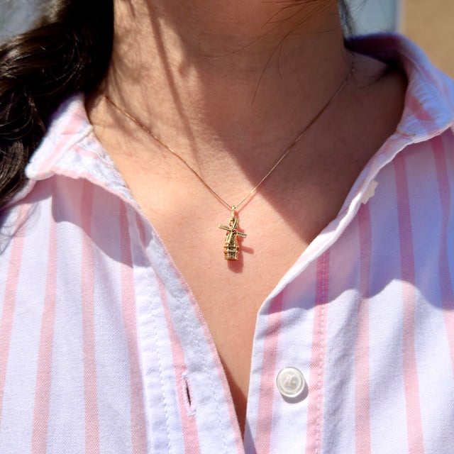 About This Charm: A whimsical vintage windmill charm circa 1960s, crafted in 14K gold with spinning blades. The semi-...