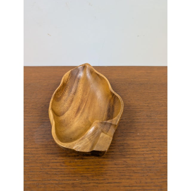 This bowl is one of a kind, hand-carved from what appears to be natural walnut by skilled artisans. Not only is it eco-...
