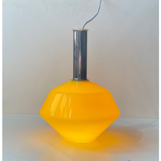 A stylish Italian ceiling lights in cased yellow glass features opaline glass interior. Its top is made from chrome plated...