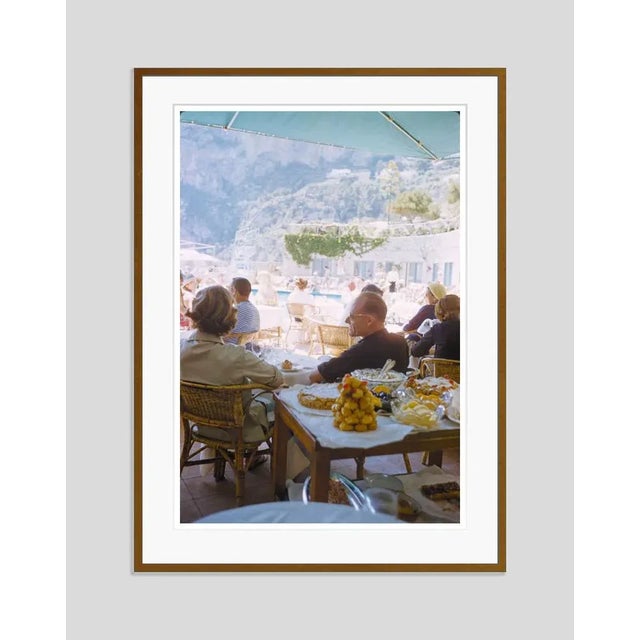 A Beachside Meal In Capri 1959 by Toni Frissell Holidaymakers enjoy a meal at a beachside restaurant in Capri, Italy, 1959...