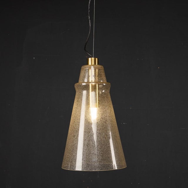 Mid 20th Century Italian Murano glass cone shaped shade pendant light with brass fittings. This light was created in the...