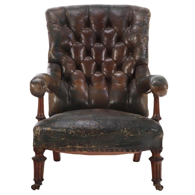A distinguished English library armchair by Gillows, branded as shown. Crafted in walnut, the chair features a deep,...